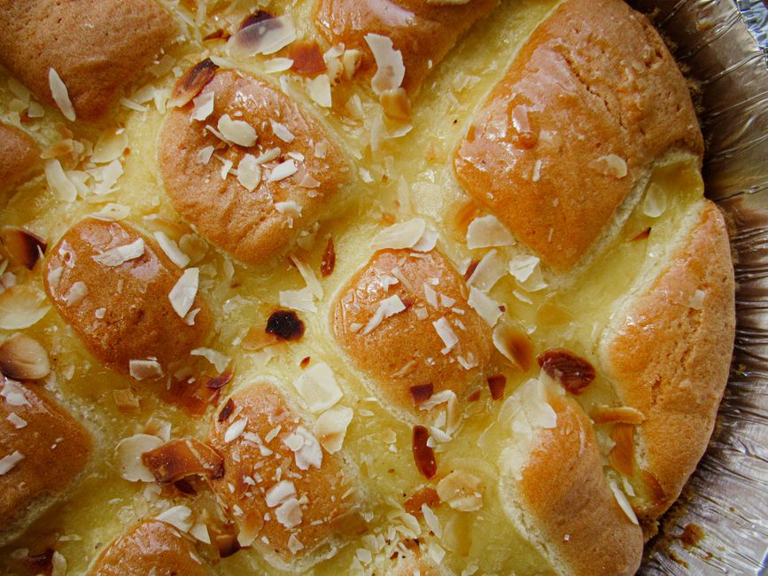 Golden-brown almond pastry with flaky texture and sliced almonds, ready for breakfast delight.