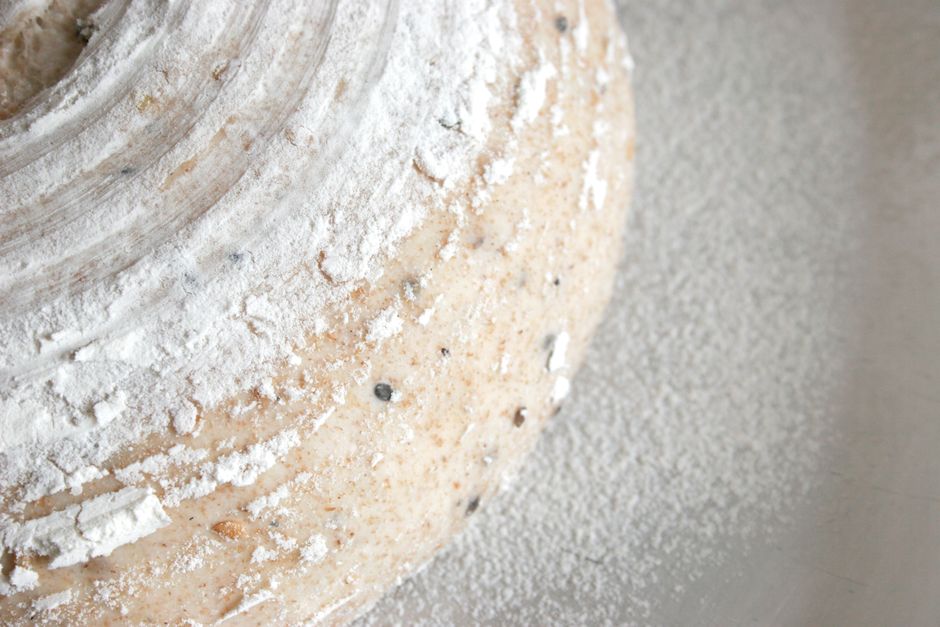 Detailed close-up of freshly prepared, flour-dusted bread dough ready for baking.